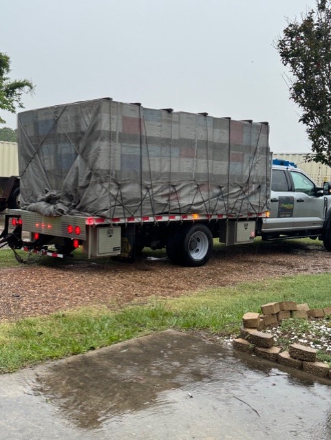 Secured transport truck loaded with hives, ensuring safe delivery for agricultural pollination